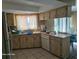 Bright kitchen with wood cabinets, double sink and dishwasher at 1461 N Felton St, Deltona, FL 32725