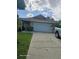 Two-car garage and a well-maintained front yard at 1461 N Felton St, Deltona, FL 32725