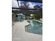 Relaxing pool area with covered patio, seating, and lush landscaping at 1461 N Felton St, Deltona, FL 32725