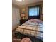 Cozy bedroom with double bed, window, and closet at 1461 N Felton St, Deltona, FL 32725