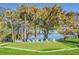 Landscaped putting green with lake views and white chairs at 1140 S Orlando Ave # F-16, Maitland, FL 32751
