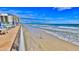 Relaxing beach access with lounge chairs and umbrellas at 2625 S Atlantic Ave # 24Nw, Daytona Beach, FL 32118