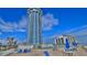 Oceanfront high-rise building with tennis courts and seating area at 2625 S Atlantic Ave # 24Nw, Daytona Beach, FL 32118