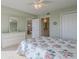 Bedroom with floral bedding and view into the adjacent bathroom at 4 Oceans West Blvd # 407B, Daytona Beach Shores, FL 32118
