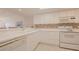 White kitchen with ample counter space and built-in appliances at 4 Oceans West Blvd # 407B, Daytona Beach Shores, FL 32118