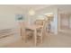 Light and airy dining area with wood table and chairs at 4 Oceans West Blvd # 407B, Daytona Beach Shores, FL 32118