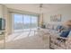 Living room with balcony access and relaxing furniture at 4 Oceans West Blvd # 407B, Daytona Beach Shores, FL 32118