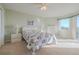 Bright bedroom with floral bedding, double dresser, and large window at 4 Oceans West Blvd # 407B, Daytona Beach Shores, FL 32118