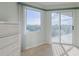 Bedroom with large window, balcony access, and water views at 4 Oceans West Blvd # 407B, Daytona Beach Shores, FL 32118