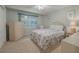 Bedroom with floral bedding and a view to balcony at 4 Oceans West Blvd # 407B, Daytona Beach Shores, FL 32118