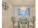 Charming dining area with glass table and view of the kitchen at 4 Oceans West Blvd # 407B, Daytona Beach Shores, FL 32118