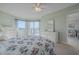 Bedroom with floral bedding, dresser, and access to a balcony with water views at 4 Oceans West Blvd # 407B, Daytona Beach Shores, FL 32118