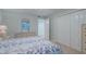 Bedroom with floral bedding and access to a hallway at 4 Oceans West Blvd # 407B, Daytona Beach Shores, FL 32118
