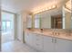 Bathroom with double vanity, large mirror, and bright lighting at 4 Oceans West Blvd # 407B, Daytona Beach Shores, FL 32118