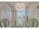 Bright dining area with glass-top table and kitchen view at 4 Oceans West Blvd # 407B, Daytona Beach Shores, FL 32118
