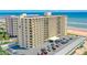 View of oceanfront building and parking area at 1415 Ocean Shore Blvd # 303, Ormond Beach, FL 32176