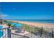 Beachfront patio area with tables and umbrellas at 1415 Ocean Shore Blvd # 303, Ormond Beach, FL 32176