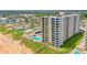 Aerial view of beachfront condo building with pool at 1415 Ocean Shore Blvd # 303, Ormond Beach, FL 32176