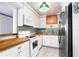 Updated kitchen with wood countertops, stainless steel appliances, and white cabinets at 1415 Ocean Shore Blvd # 303, Ormond Beach, FL 32176
