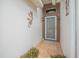 Front entrance with tiled flooring, gray door, and gecko decor at 316 Dahoon Holly Dr, Daytona Beach, FL 32117