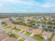 Aerial view of community with lake and homes at 316 Dahoon Holly Dr, Daytona Beach, FL 32117