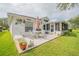 Relaxing patio overlooking a pond with seating, umbrella, and greenery at 316 Dahoon Holly Dr, Daytona Beach, FL 32117