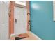 Entryway with a white door and teal accent wall at 316 Dahoon Holly Dr, Daytona Beach, FL 32117