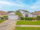 Cute one-story home with palm tree and well-maintained lawn at 316 Dahoon Holly Dr, Daytona Beach, FL 32117
