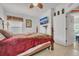 Bedroom with a wooden four-poster bed and ceiling fan at 316 Dahoon Holly Dr, Daytona Beach, FL 32117