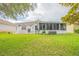 Spacious backyard with patio, screened enclosure, and lush lawn at 316 Dahoon Holly Dr, Daytona Beach, FL 32117