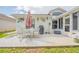 Back patio with seating area, grill, and sunshade umbrella at 316 Dahoon Holly Dr, Daytona Beach, FL 32117