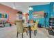 Charming dining area with a glass-top table and colorful chairs at 316 Dahoon Holly Dr, Daytona Beach, FL 32117