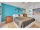Spacious main bedroom with a large bed and teal accent wall at 316 Dahoon Holly Dr, Daytona Beach, FL 32117