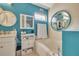 Bathroom with a large round mirror and a bathtub at 316 Dahoon Holly Dr, Daytona Beach, FL 32117
