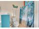 Bathroom with a toilet, shower, and beach-themed decor at 316 Dahoon Holly Dr, Daytona Beach, FL 32117