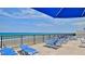 Beachfront lounge chairs and umbrella on a deck at 2987 S Atlantic Ave # D060, Daytona Beach, FL 32118