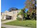 Two story townhome with attached garage, landscaping, and palm tree at 1630 Primo Ct, Daytona Beach, FL 32117