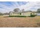Side view of the house showcasing landscaping and yard at 10170 Sw 96Th Ct, Ocala, FL 34481