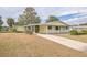 Ranch style home with a long driveway and mature trees at 10170 Sw 96Th Ct, Ocala, FL 34481