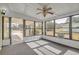 Bright sunroom with windowed walls and ceiling fan at 10170 Sw 96Th Ct, Ocala, FL 34481