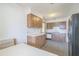 Bright kitchen features wood cabinets, and a view into the dining area at 10170 Sw 96Th Ct, Ocala, FL 34481