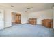 Spacious living room with piano, cabinet, and access to other rooms at 10170 Sw 96Th Ct, Ocala, FL 34481