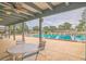 Community pool and patio area with shaded seating at 10170 Sw 96Th Ct, Ocala, FL 34481
