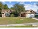 Brick home with two-car garage and well-maintained lawn at 1460 Ne Old Mill Dr, Deltona, FL 32725