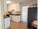 Galley kitchen with white cabinets and laminate flooring at 2201 Flamingo Ave, Deltona, FL 32738