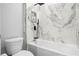 Bathroom with white bathtub, marble tile, and black fixtures at 3295 Arch Ave, Ormond Beach, FL 32174