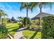 Curved brick pathway meanders through a beautifully landscaped backyard at 4345 Heath Land Ln, Lake Wales, FL 33859