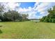 Large backyard with lake view and lush green grass at 660 Saxon Blvd, Deltona, FL 32725