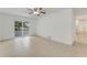 Living room with tile floors, sliding glass doors, and access to a patio at 660 Saxon Blvd, Deltona, FL 32725