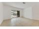 Living room with tile floors and sliding glass doors to a patio overlooking a lake at 660 Saxon Blvd, Deltona, FL 32725